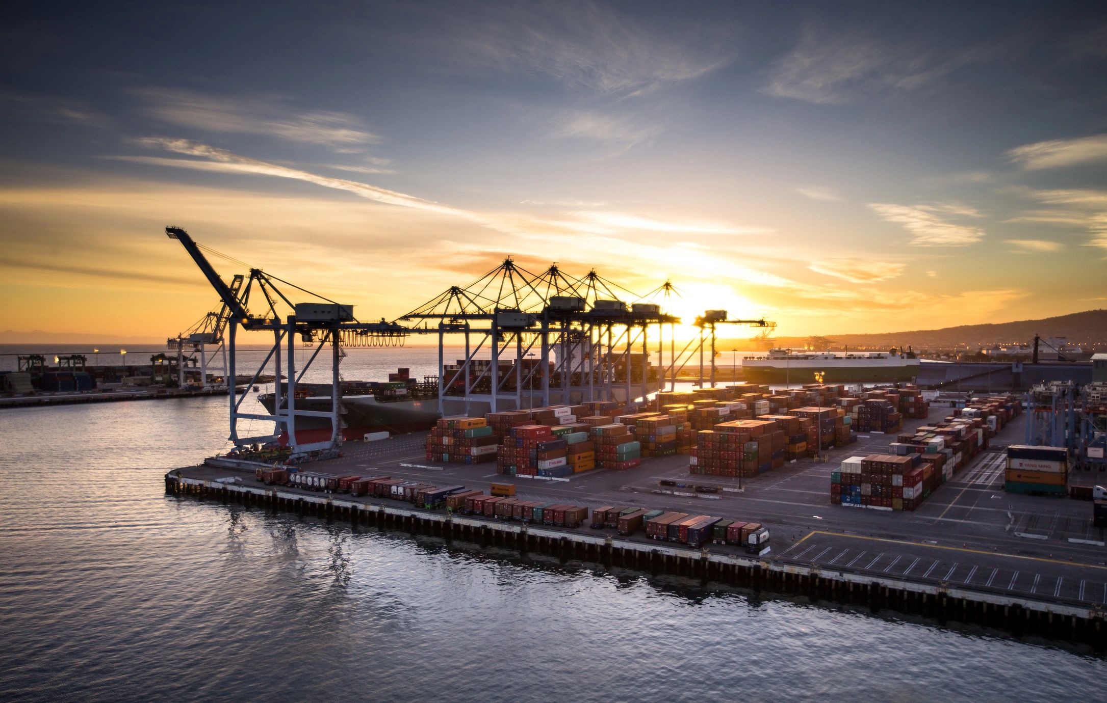 Container port at sunset showing global logistics operations